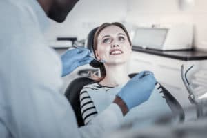 Just attention. Kind female person demonstrating her smile while visiting dentist